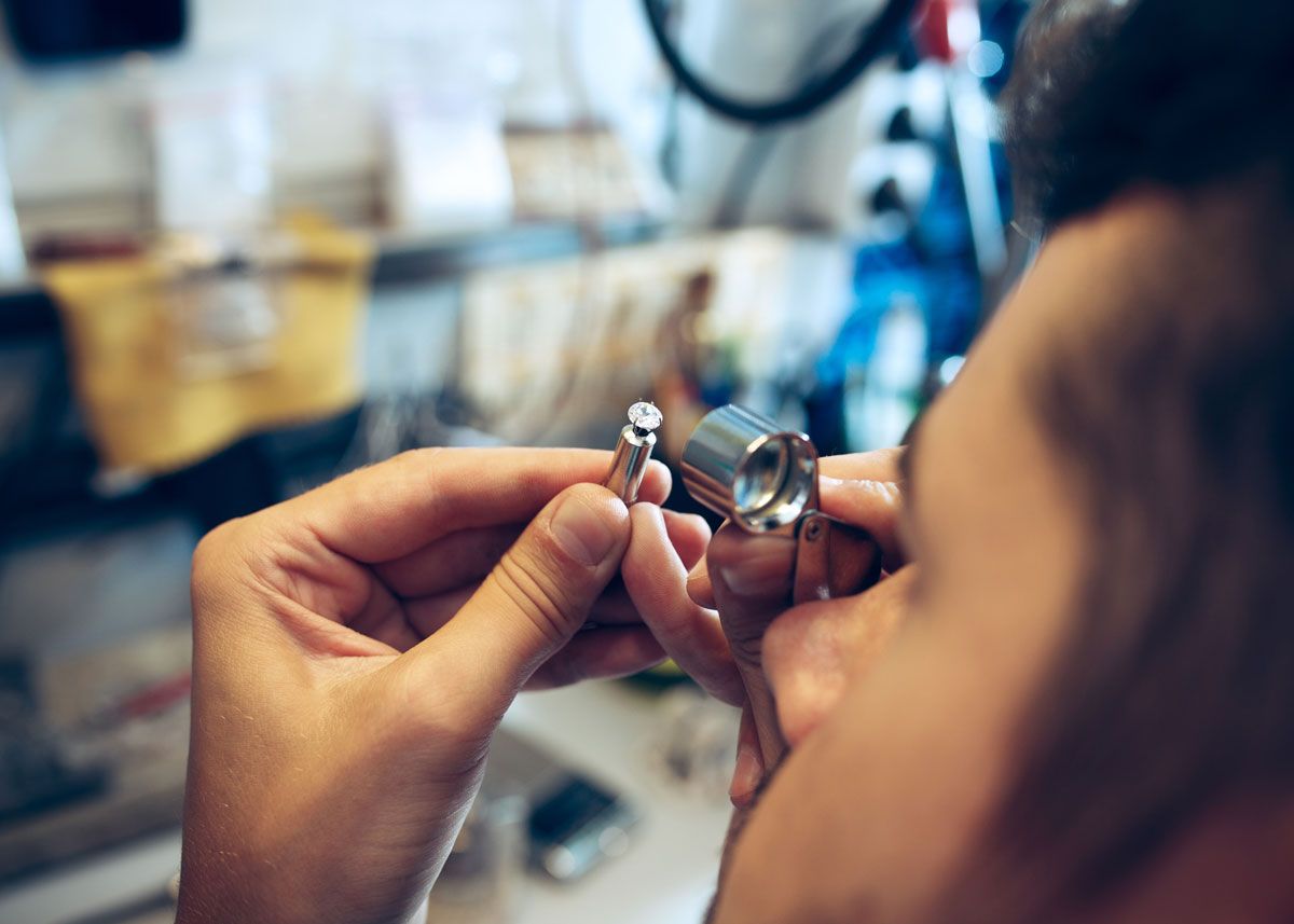 Jeweler looking through a loupe to get a close up view of a diamond