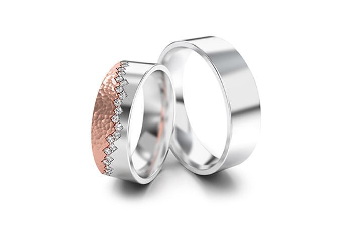 Two mixed wedding bands, one rose gold and silver with diamonds, the other silver