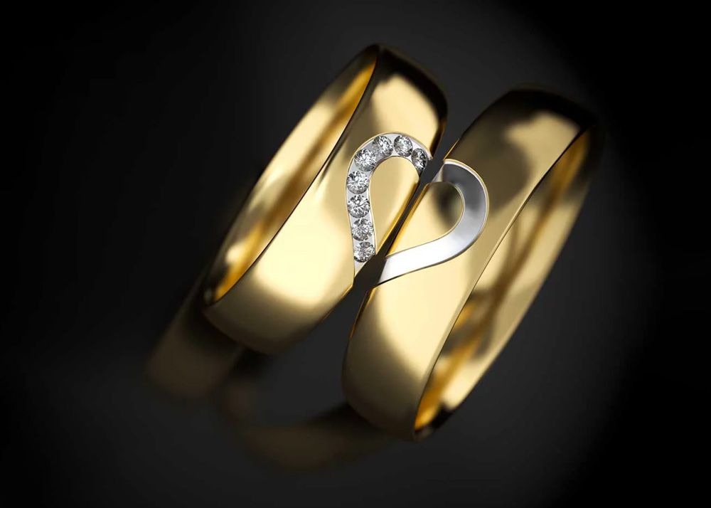 Two gold rings, side by side, with a heart design.
