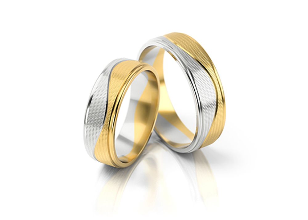 Two gold and silver wedding bands with unique design and texture.