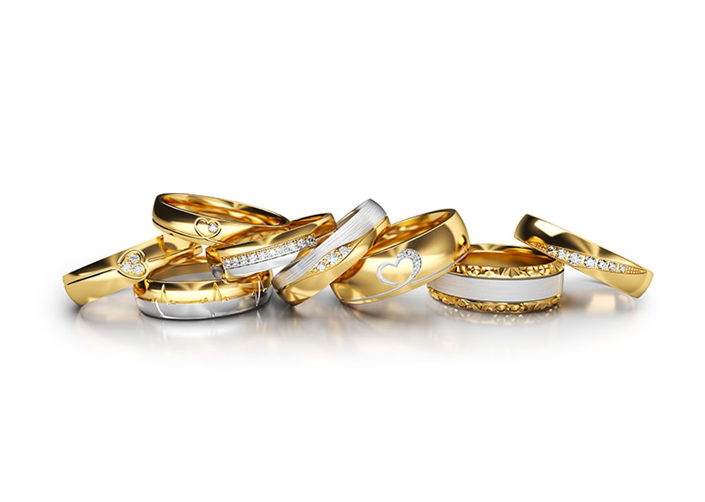 A group of gold and silver rings spread out on a white background